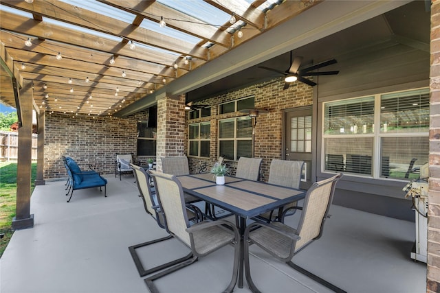 view of patio featuring fence, a pergola, a ceiling fan, and outdoor dining space