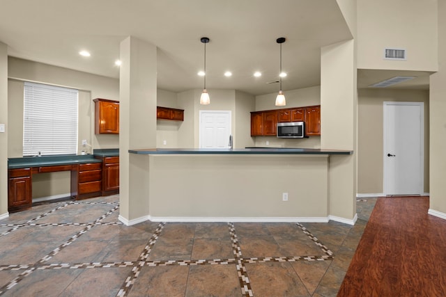 kitchen featuring stainless steel microwave, dark countertops, baseboards, visible vents, and recessed lighting
