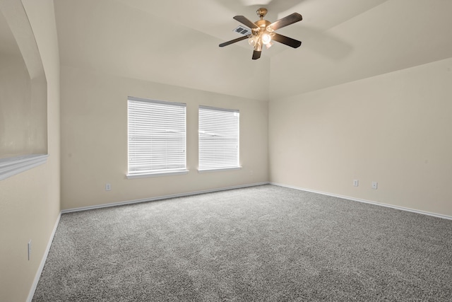 carpeted spare room featuring arched walkways, a ceiling fan, vaulted ceiling, and baseboards