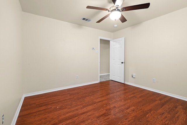 unfurnished room with baseboards, a ceiling fan, wood finished floors, and visible vents
