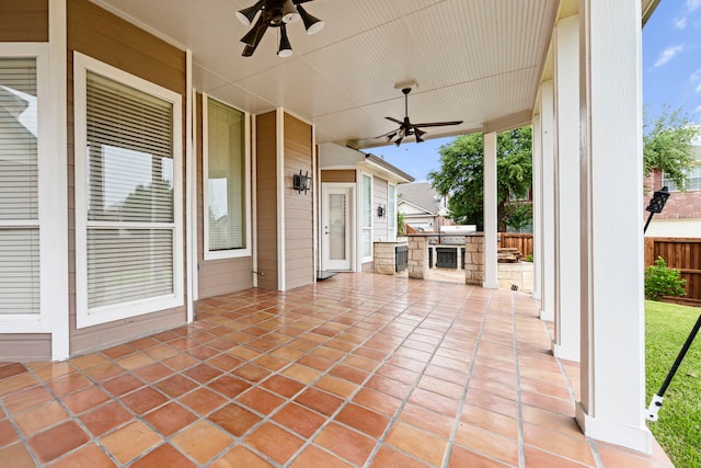 view of patio with fence, a ceiling fan, and area for grilling
