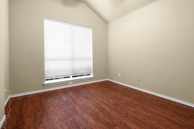 unfurnished room featuring vaulted ceiling, baseboards, and dark wood-style flooring