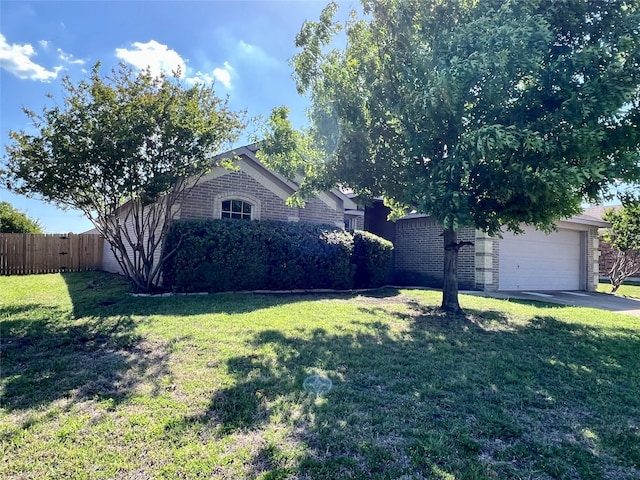 525 Reagan Ln, Burleson, TX 76028 - view of front facade featuring brick siding, fence, and a front yard