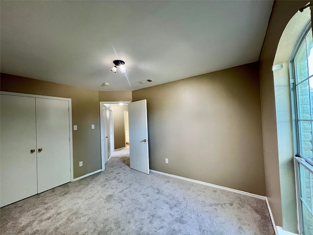525 Reagan Ln, Burleson, TX 76028 - unfurnished bedroom with visible vents, baseboards, carpet floors, and a closet
