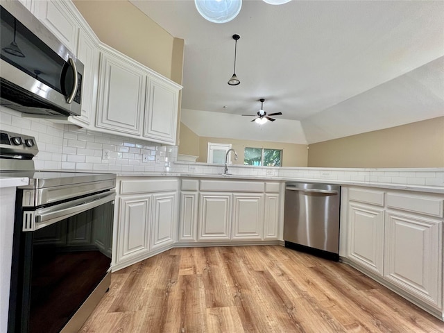 525 Reagan Ln, Burleson, TX 76028 - kitchen featuring light countertops, light wood-style floors, white cabinets, and stainless steel appliances