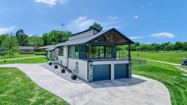 exterior space with a lawn, driveway, stone siding, and a garage