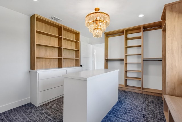 walk in closet featuring a notable chandelier and visible vents
