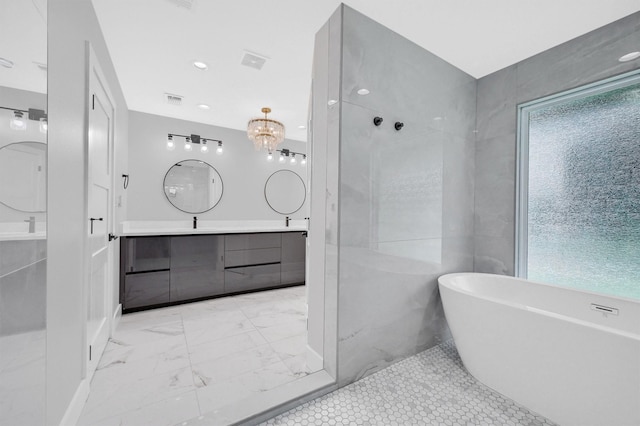 bathroom with a freestanding bath, walk in shower, vanity, and visible vents