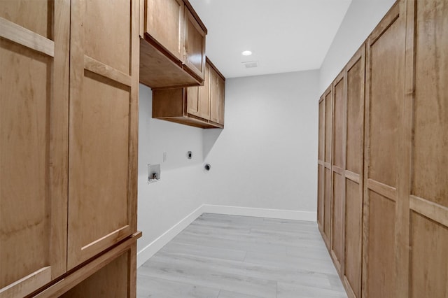 clothes washing area with hookup for a washing machine, baseboards, electric dryer hookup, cabinet space, and light wood-style flooring
