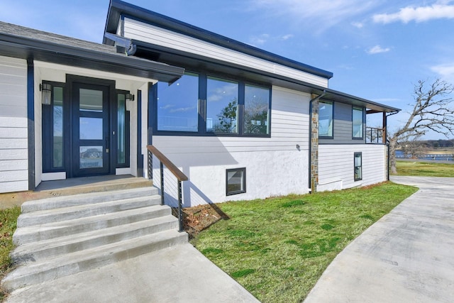 property entrance with a yard