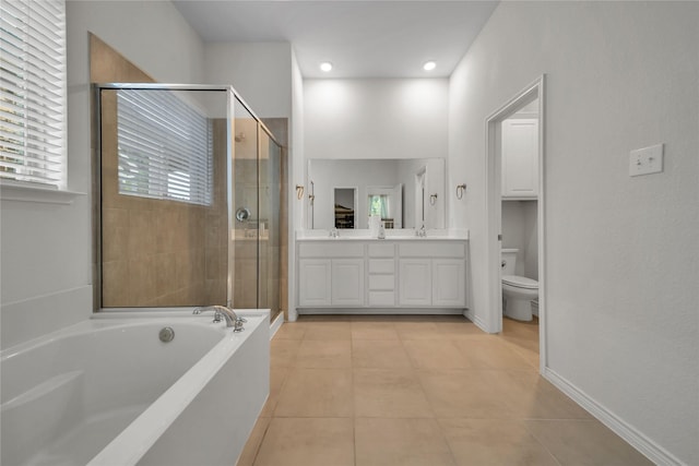 full bath featuring a bath, tile patterned floors, double vanity, toilet, and a stall shower
