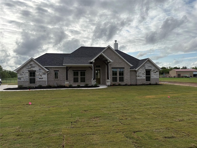 989 County Road 1304, Bridgeport, TX 76426 - view of front of house featuring a chimney, a front lawn, brick siding, and a shingled roof