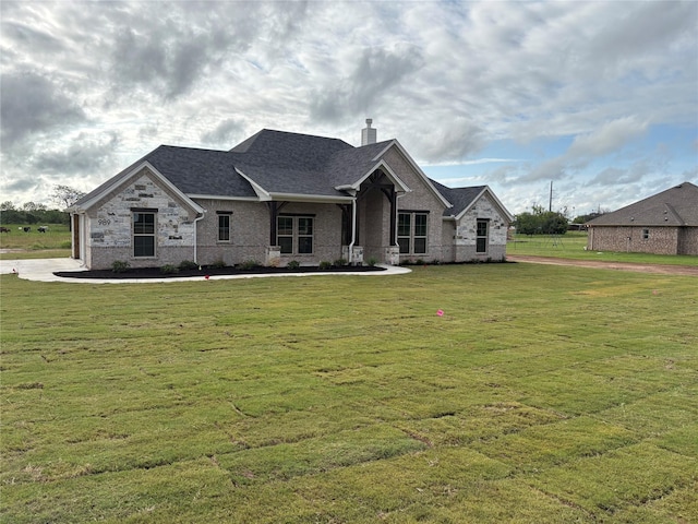 989 County Road 1304, Bridgeport, TX 76426 - view of front of house featuring a chimney, a front lawn, brick siding, and a shingled roof