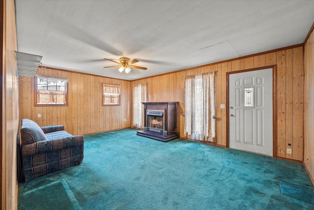 unfurnished living room featuring a warm lit fireplace, wooden walls, and carpet