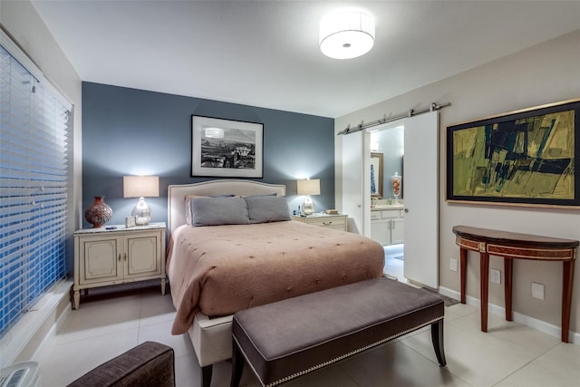 2535 Wedglea Dr Unit 114, Dallas, TX 75211 - bedroom with a barn door, baseboards, ensuite bathroom, and light tile patterned floors