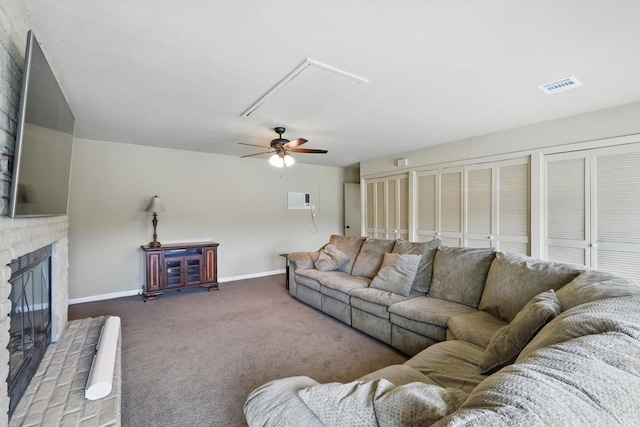 living area with ceiling fan, visible vents, a brick fireplace, baseboards, and dark colored carpet