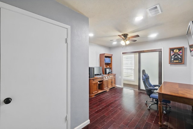 office space featuring baseboards, a ceiling fan, dark wood-style flooring, and visible vents