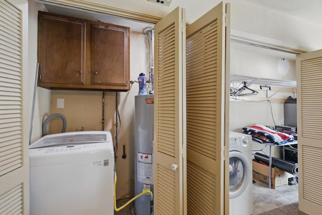 laundry area with water heater, cabinet space, and washer / clothes dryer