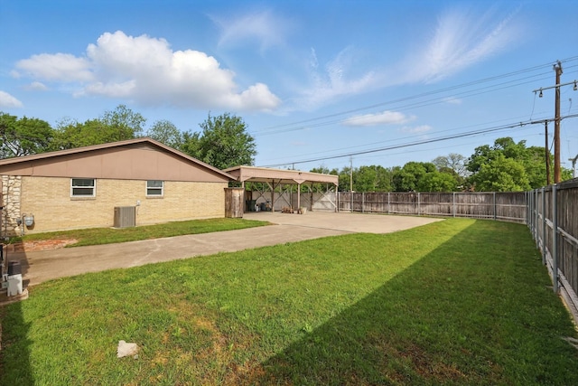 view of yard with a fenced backyard, a patio, and central air condition unit