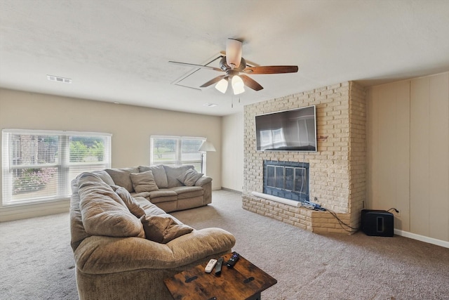 living room with ceiling fan, a fireplace, and carpet flooring