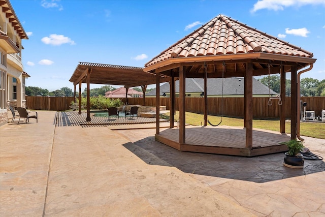view of patio / terrace with a gazebo, a pergola, a fenced backyard, and a deck