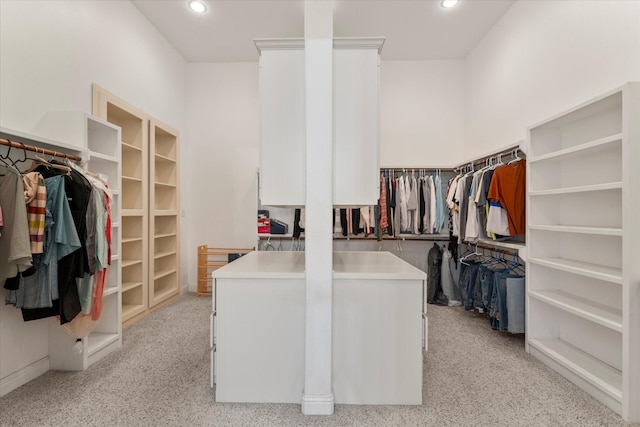 walk in closet featuring light colored carpet