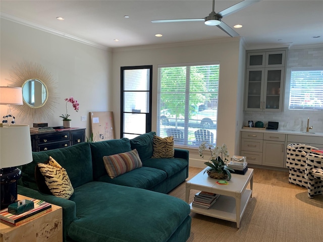 living room featuring healthy amount of natural light, a ceiling fan, ornamental molding, and recessed lighting