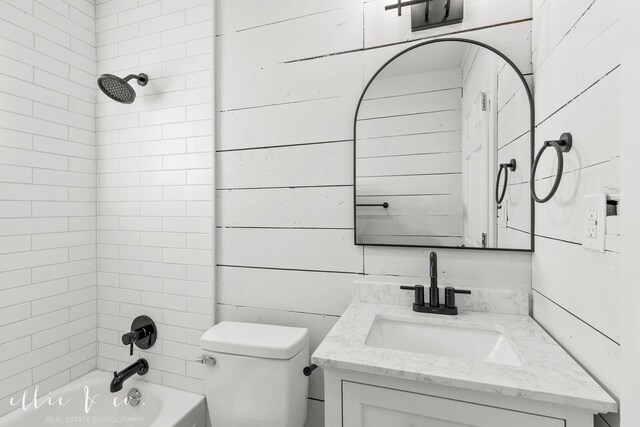 bathroom with shower / bathtub combination, toilet, and vanity