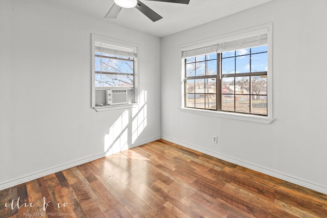 empty room with cooling unit, hardwood / wood-style flooring, baseboards, and ceiling fan
