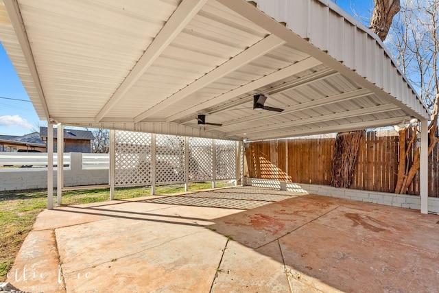 view of patio with a carport and fence