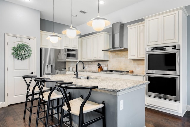 7512 Sabine Dr, Mckinney, TX 75071 - kitchen featuring wall chimney range hood, a sink, appliances with stainless steel finishes, backsplash, and light stone counters