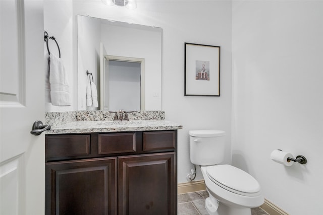 7512 Sabine Dr, Mckinney, TX 75071 - half bathroom featuring toilet, baseboards, vanity, and tile patterned floors
