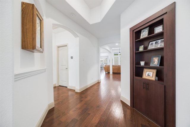 7512 Sabine Dr, Mckinney, TX 75071 - hall with arched walkways, dark wood finished floors, and baseboards