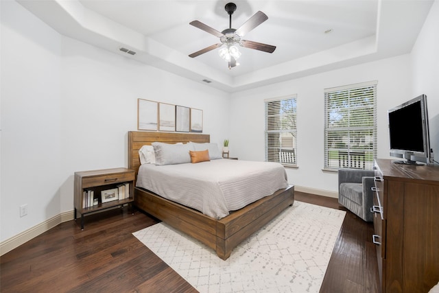 7512 Sabine Dr, Mckinney, TX 75071 - bedroom featuring a raised ceiling, dark wood-style flooring, baseboards, and ceiling fan