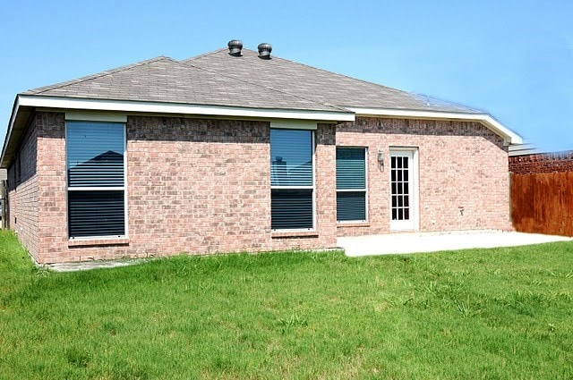 3929 Big Thicket Dr, Fort Worth, TX 76244 - back of property featuring a lawn, fence, a patio, and brick siding