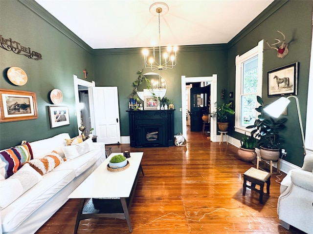 501 N Austin St, Comanche, TX 76442 - living room featuring a chandelier, wood finished floors, ornamental molding, and baseboards