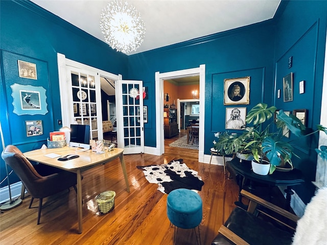 501 N Austin St, Comanche, TX 76442 - home office featuring french doors, baseboards, crown molding, wood finished floors, and a chandelier