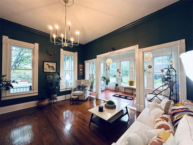 501 N Austin St, Comanche, TX 76442 - living room with a chandelier, wood-type flooring, baseboards, and ornamental molding