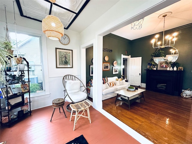 501 N Austin St, Comanche, TX 76442 - living room with wood-type flooring, a chandelier, and a fireplace