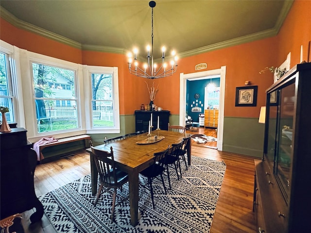 501 N Austin St, Comanche, TX 76442 - dining space with a chandelier, wood finished floors, plenty of natural light, and ornamental molding