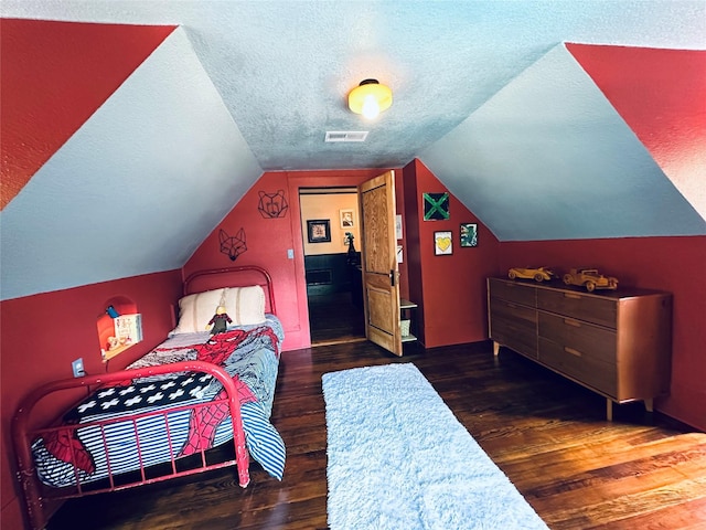 501 N Austin St, Comanche, TX 76442 - bedroom with a textured ceiling, wood finished floors, and vaulted ceiling