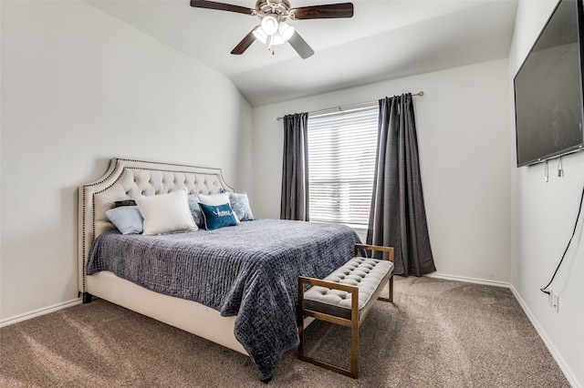 carpeted bedroom with vaulted ceiling, baseboards, and ceiling fan
