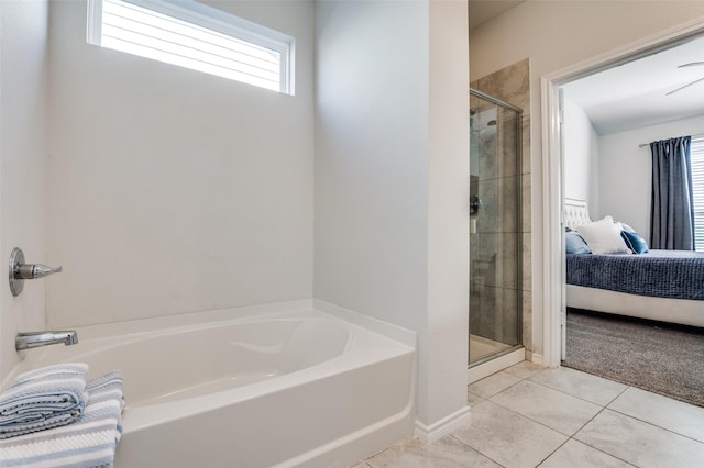 ensuite bathroom with a garden tub, ensuite bath, tile patterned flooring, and a shower stall