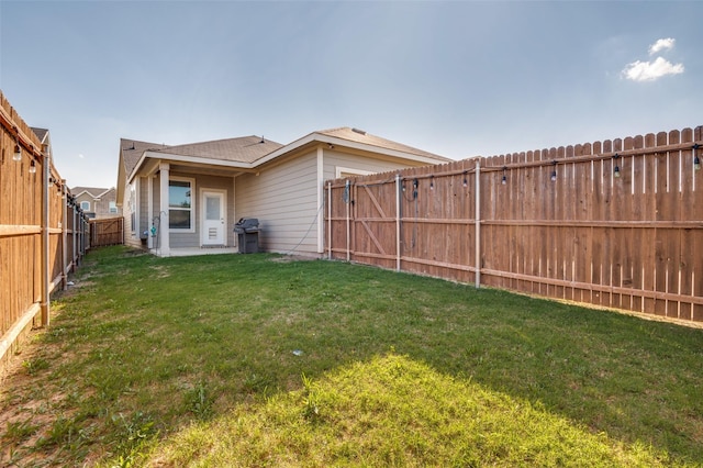 view of yard with a fenced backyard