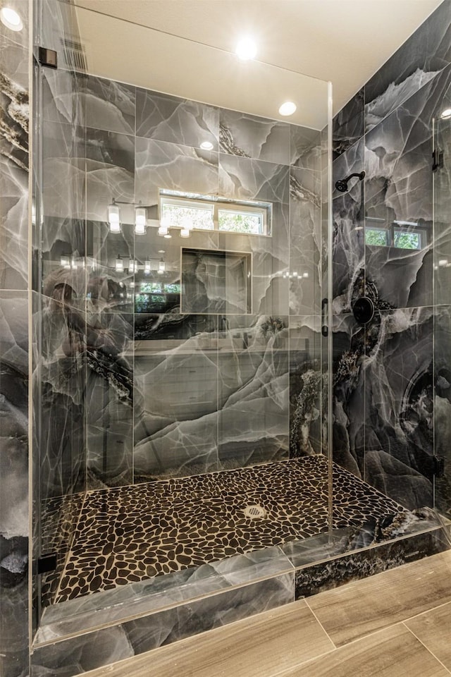 bathroom with recessed lighting and a marble finish shower