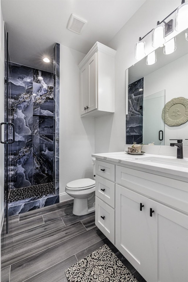 bathroom featuring visible vents, vanity, toilet, recessed lighting, and a stall shower
