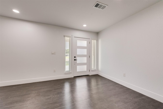 entryway with dark wood finished floors, baseboards, visible vents, and recessed lighting