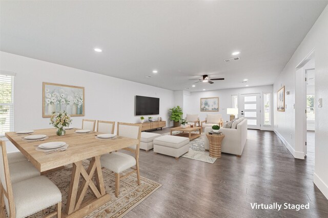 living room featuring a wealth of natural light, visible vents, recessed lighting, and dark wood-style floors