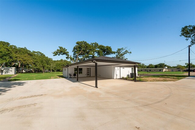 exterior space with concrete driveway and a carport