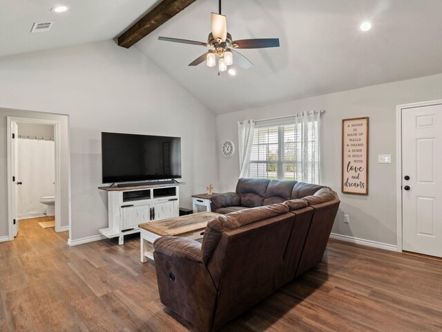 living room with a ceiling fan, visible vents, wood finished floors, baseboards, and beamed ceiling